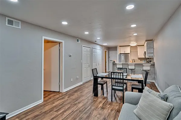 a view of a dining room with furniture and wooden floor