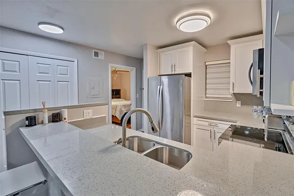 a kitchen with stainless steel appliances a stove microwave and sink