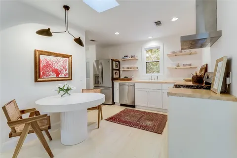 a kitchen with a sink cabinets and window