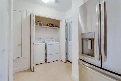 a utility room with cabinets washer and dryer