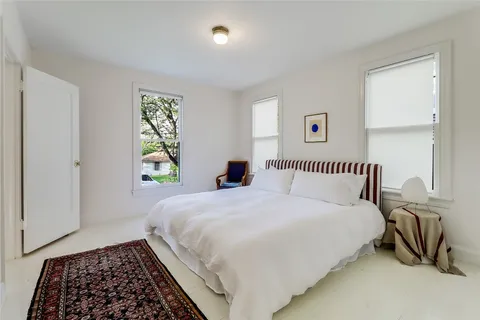 a bedroom with bed and a window
