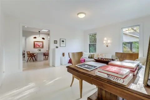 a living room with furniture and next to a window