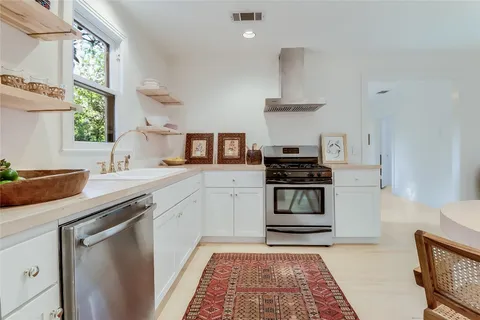 a kitchen with a sink and a stove top oven