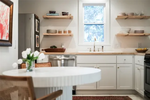a kitchen with a table and cabinets