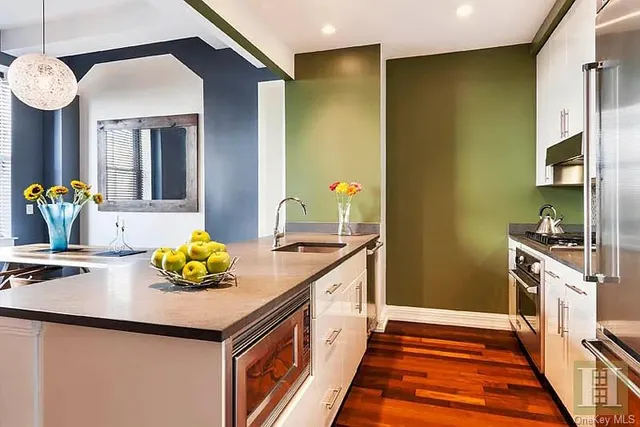 a kitchen with stainless steel appliances a sink and cabinets