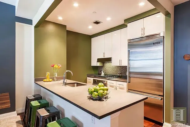 a kitchen with kitchen island granite countertop a sink and counter space