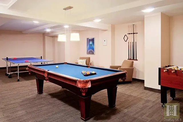 a room with furniture pool table and windows
