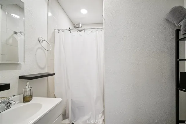 a bathroom with a sink toilet and mirror