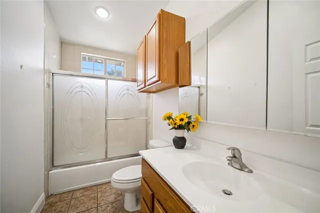 a bathroom with a sink toilet and mirror