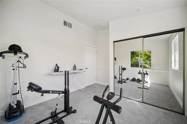 a living room with furniture a flat screen tv and a window