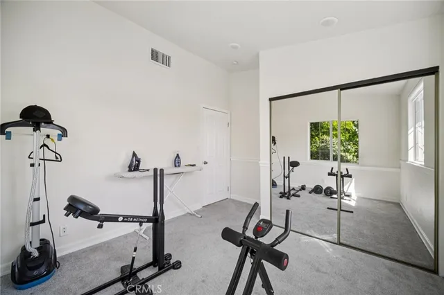 a living room with furniture a flat screen tv and a window