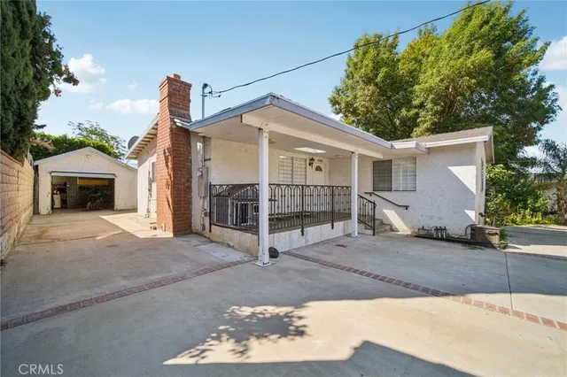 a large white kitchen with furniture and a refrigerator