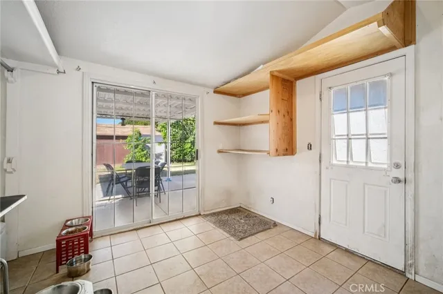 a view of room with furniture and a refrigerator