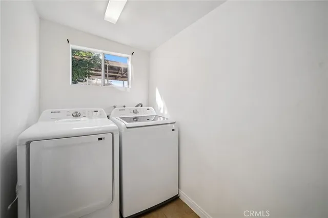 a pathway of a house with a yard and large trees