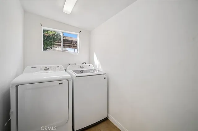 a pathway of a house with a yard and large trees