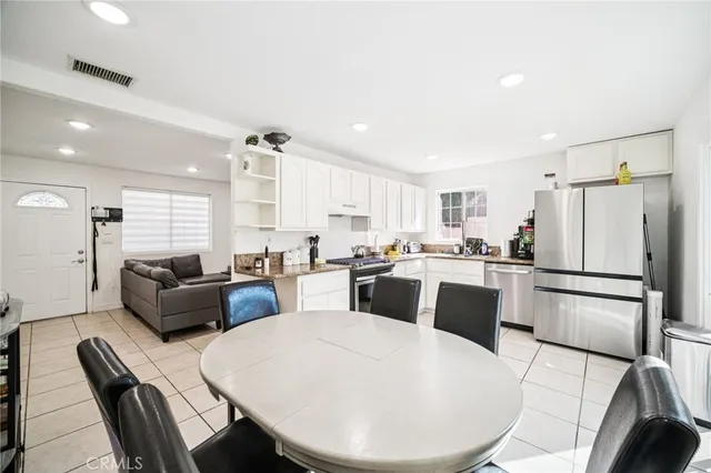 a kitchen with granite countertop appliances cabinets and a sink