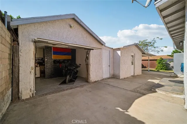 a view of a patio with table and chairs and potted plants