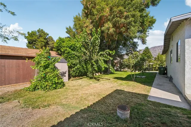 a view of a house with backyard and sitting area