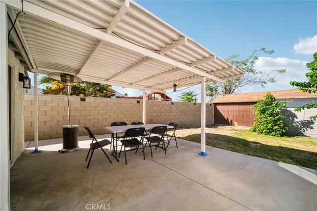 a backyard of a house with table and chairs
