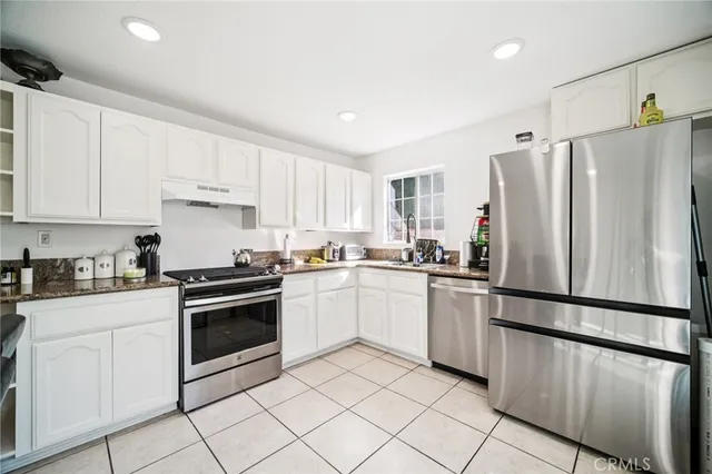 a view of a dining room with furniture and a kitchen