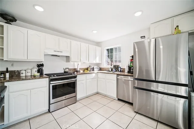 a view of a dining room with furniture and a kitchen