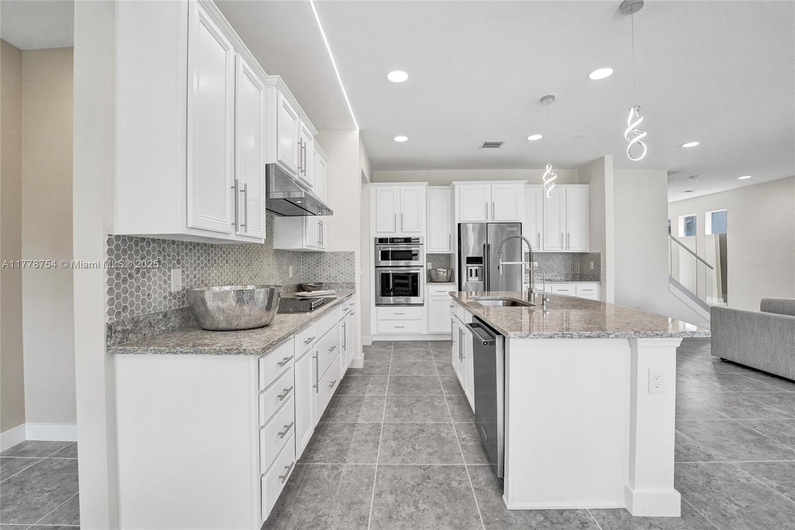 1348 Silk Oak Drive Hollywood, FL 33021 - Photo 29 of 100 a kitchen with stainless steel appliances granite countertop a sink and cabinets