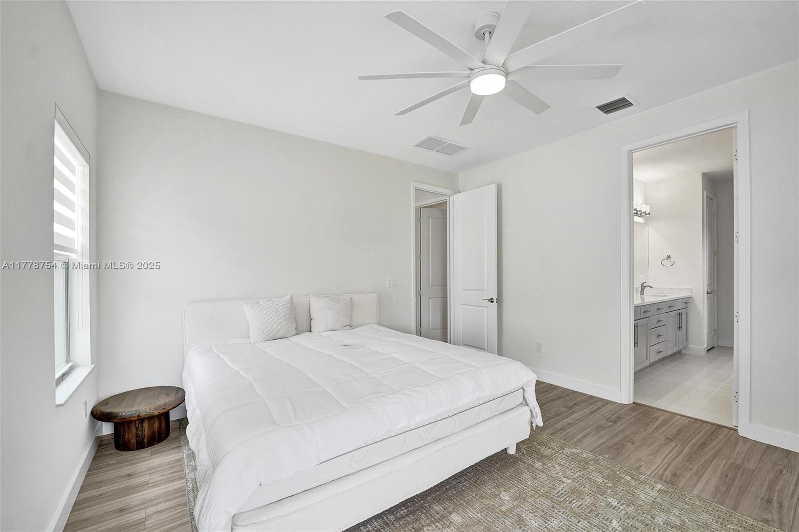 1348 Silk Oak Drive Hollywood, FL 33021 - Photo 41 of 100 a bedroom with a bed and a ceiling fan