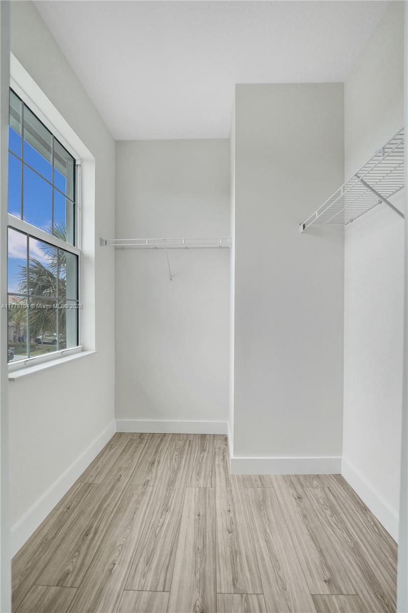 1348 Silk Oak Drive Hollywood, FL 33021 - Photo 57 of 100 a view of an empty room with wooden floor and a window