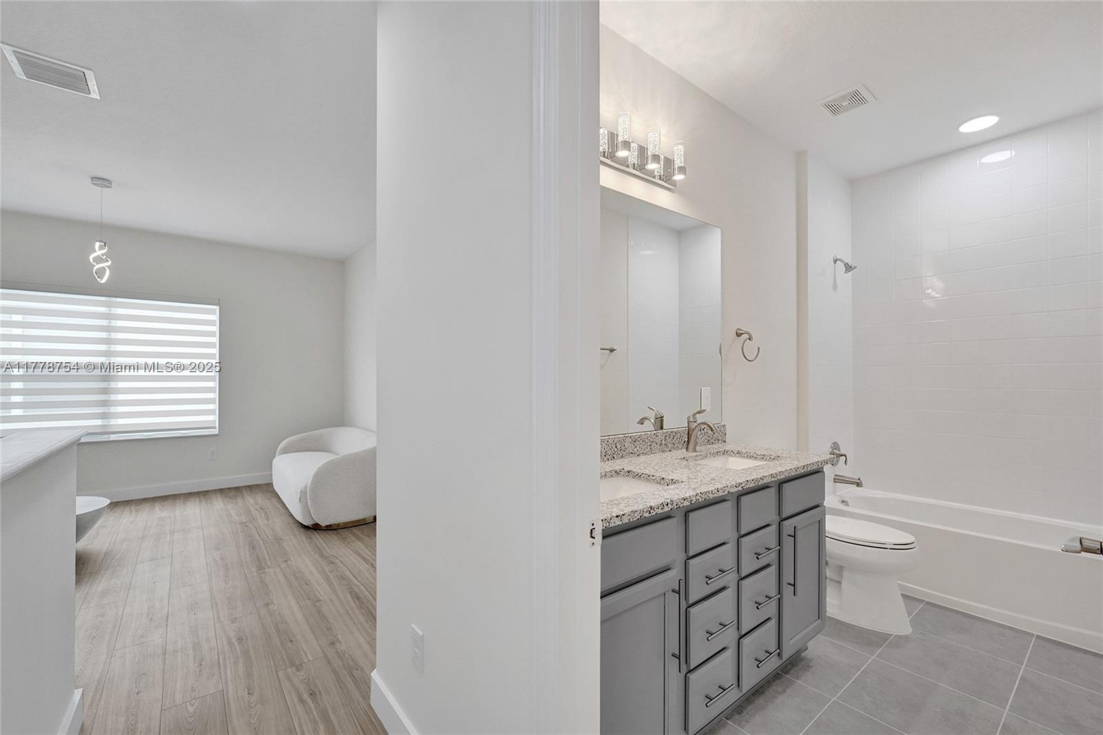 1348 Silk Oak Drive Hollywood, FL 33021 - Photo 58 of 100 a spacious bathroom with a granite countertop sink a toilet and a mirror