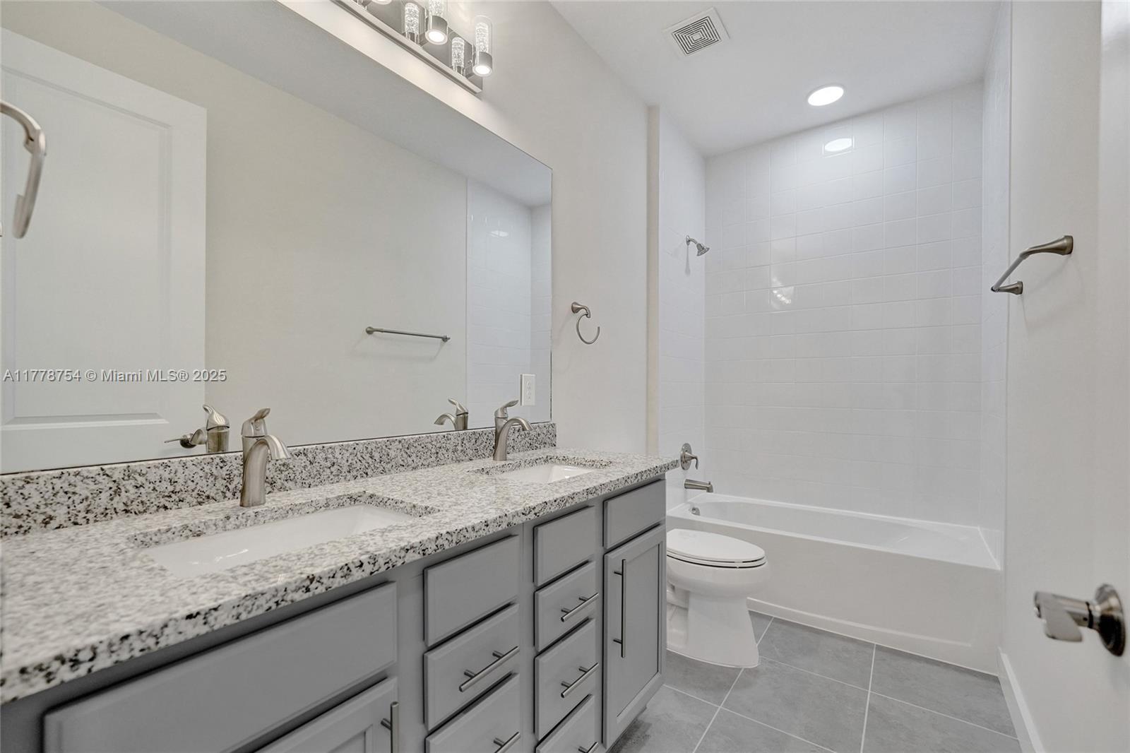 1348 Silk Oak Drive Hollywood, FL 33021 - Photo 59 of 100 a bathroom with a granite countertop sink a toilet and shower