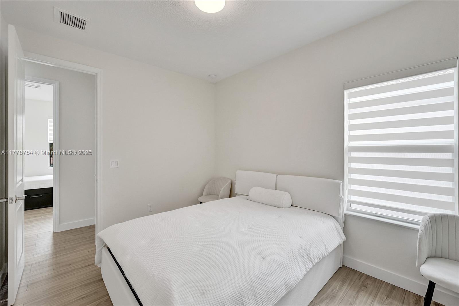 1348 Silk Oak Drive Hollywood, FL 33021 - Photo 63 of 100 a bedroom with a bed and a window