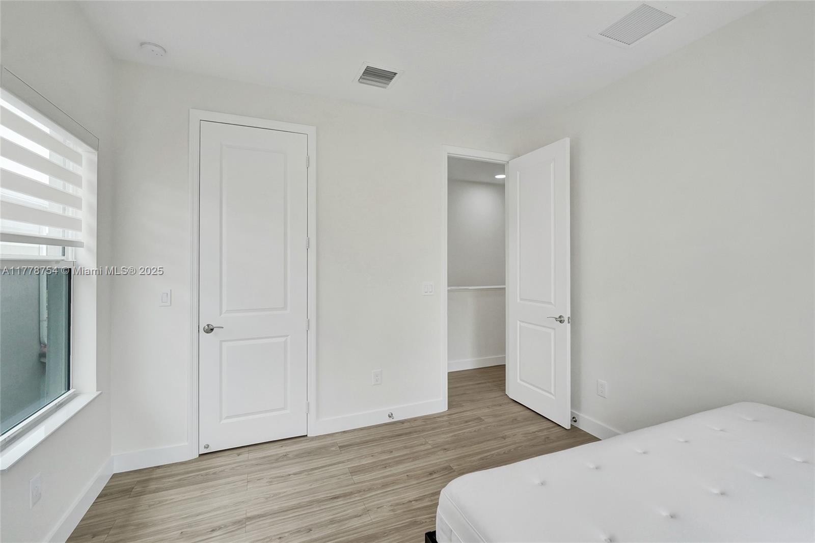 1348 Silk Oak Drive Hollywood, FL 33021 - Photo 67 of 100 a bedroom with a bed and wooden floor