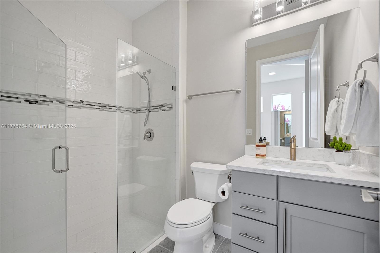 1348 Silk Oak Drive Hollywood, FL 33021 - Photo 7 of 100 a bathroom with a double vanity sink toilet mirror and shower