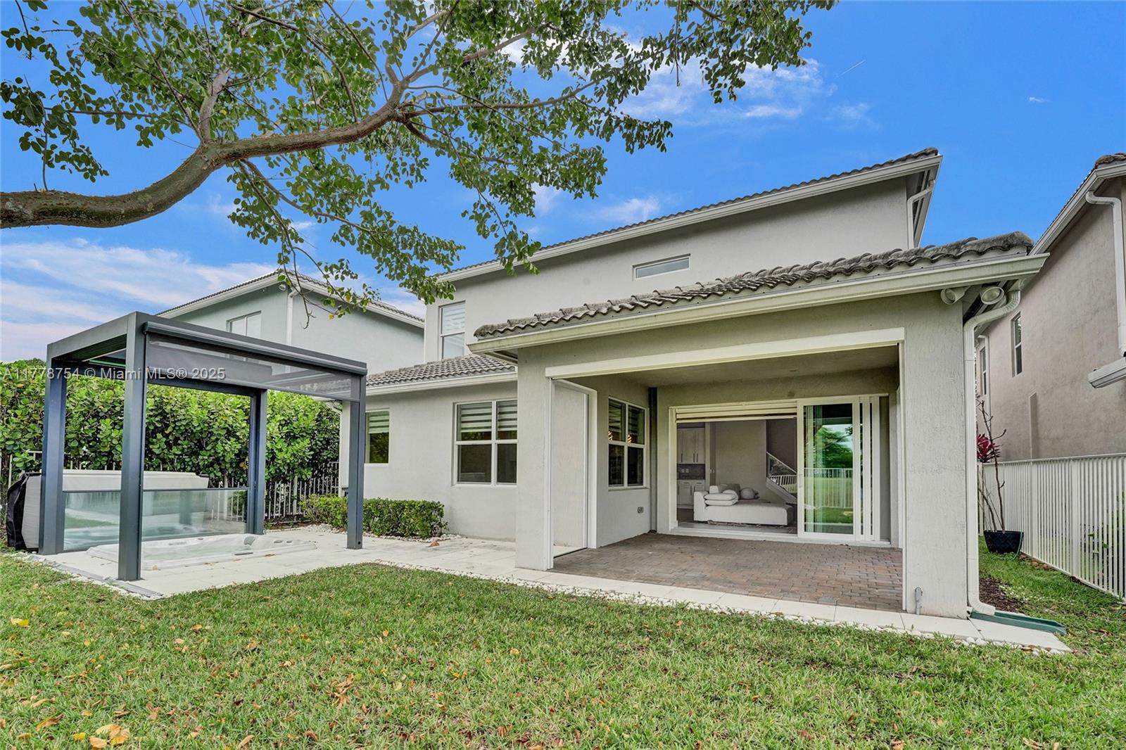 1348 Silk Oak Drive Hollywood, FL 33021 - Photo 74 of 100 a view of a patio with table and chairs and floor to ceiling window