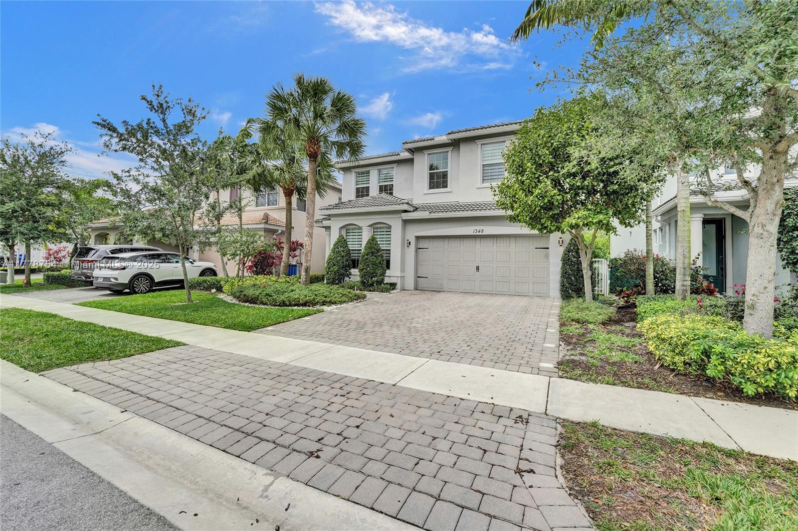 1348 Silk Oak Drive Hollywood, FL 33021 - Photo 79 of 100 a view of a white house with a yard and large tree