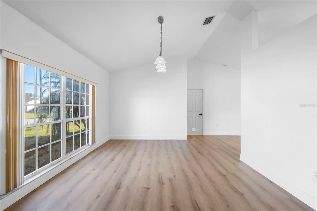 4395 Comfort Street Cocoa, FL 32927 - Photo 13 of 44 a view of a room with wooden floor and windows