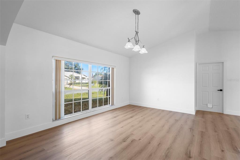 4395 Comfort Street Cocoa, FL 32927 - Photo 14 of 44 a view of an empty room with wooden floor and a window