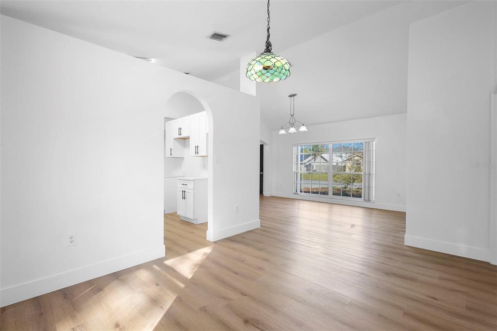 4395 Comfort Street Cocoa, FL 32927 - Photo 16 of 44 a view of an empty room with a window and wooden floor