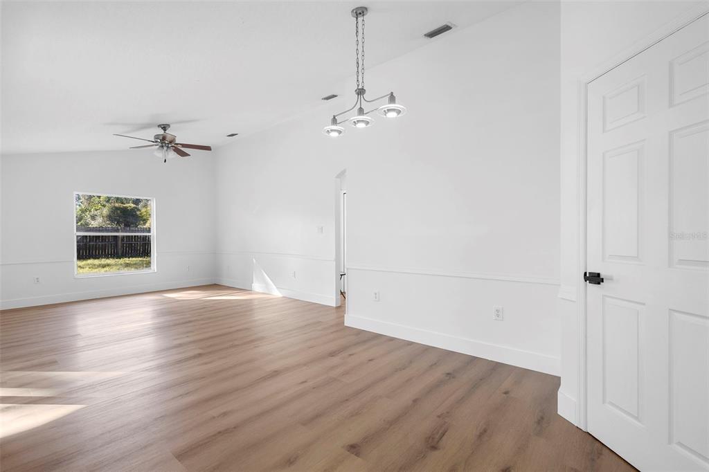 4395 Comfort Street Cocoa, FL 32927 - Photo 18 of 44 a view of a room with a ceiling fan a ceiling fan and hardwood floor
