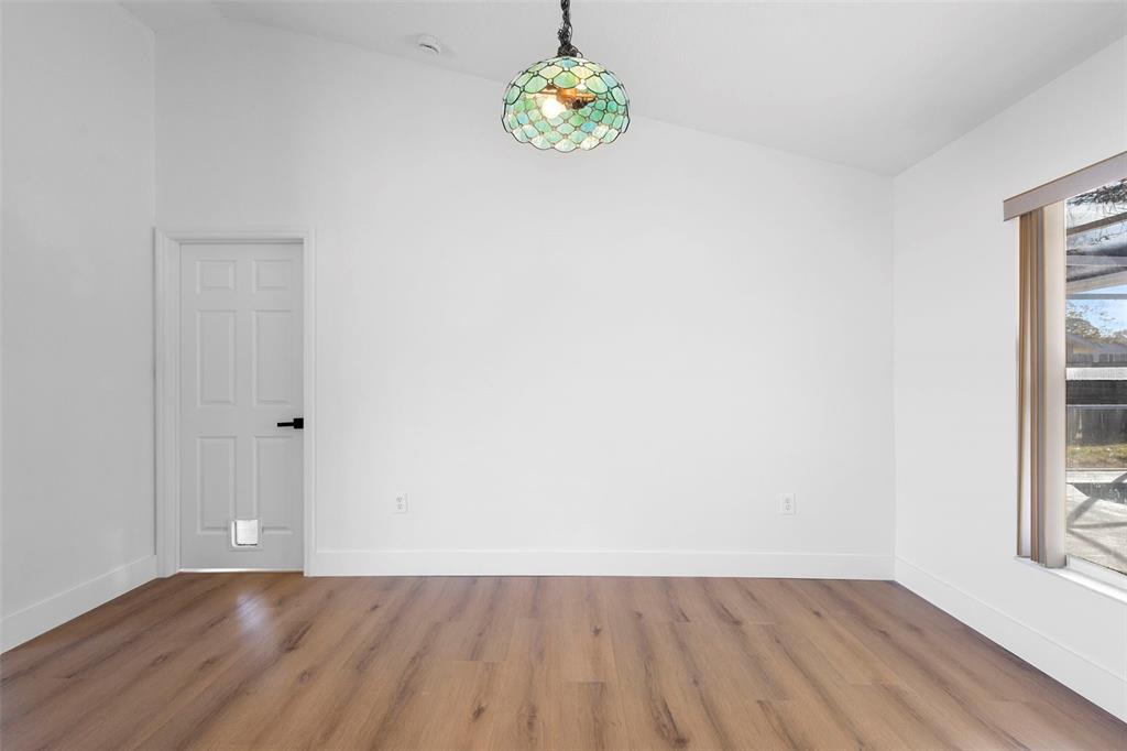 4395 Comfort Street Cocoa, FL 32927 - Photo 20 of 44 a view of an empty room with window and wooden floor