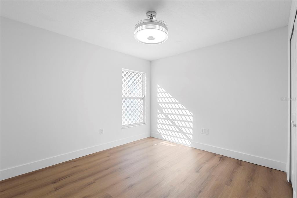4395 Comfort Street Cocoa, FL 32927 - Photo 32 of 44 an empty room with wooden floor and windows