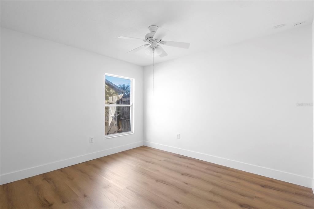 4395 Comfort Street Cocoa, FL 32927 - Photo 33 of 44 a view of an empty room with wooden floor and a window