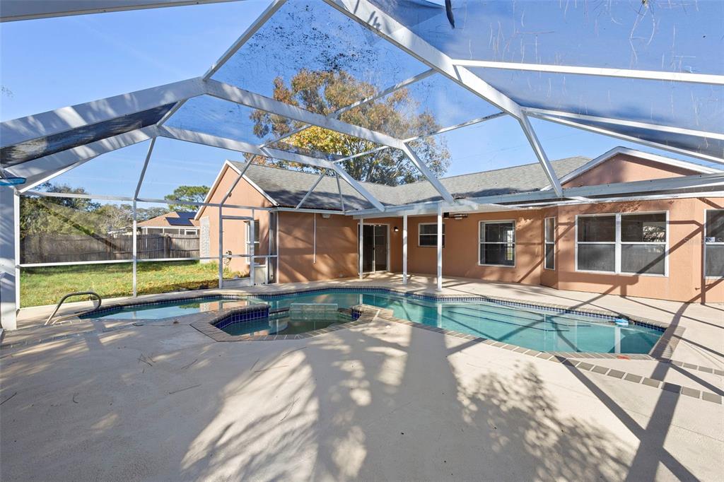 4395 Comfort Street Cocoa, FL 32927 - Photo 36 of 44 a view of a house with backyard sitting area and tub