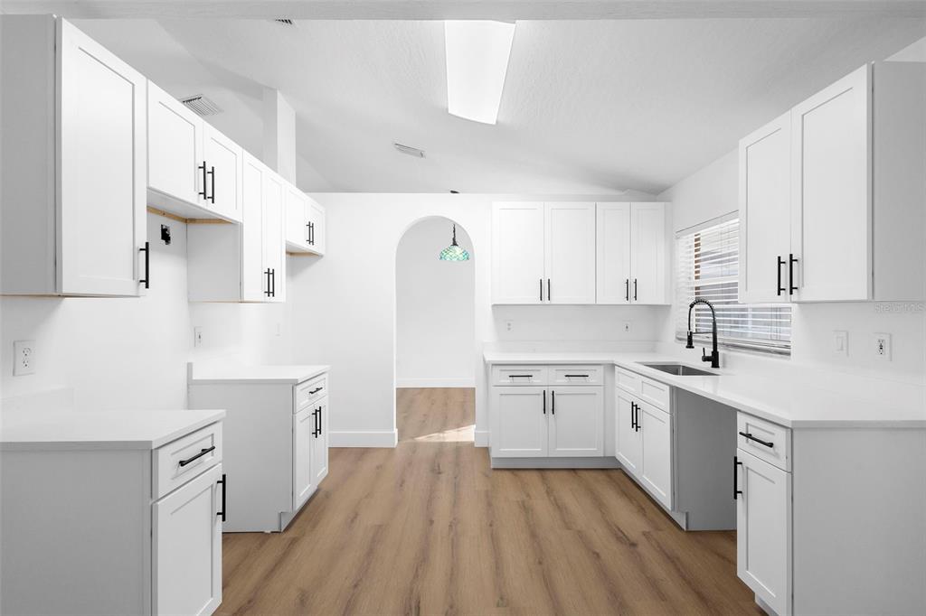 4395 Comfort Street Cocoa, FL 32927 - Photo 6 of 44 a kitchen with white cabinets appliances and sink