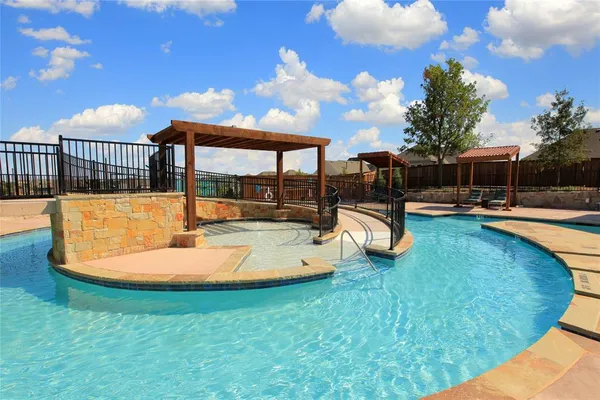 a swimming pool with outdoor seating and yard