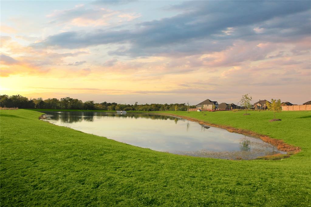 1406 Potenza Road Fate, TX 75087 - Photo 23 of 23 a view of a lake with houses in the back
