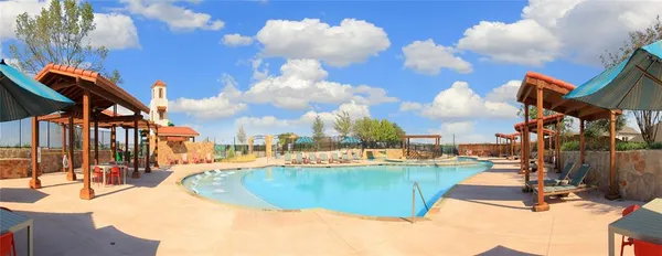 a view of a swimming pool with a table and chairs
