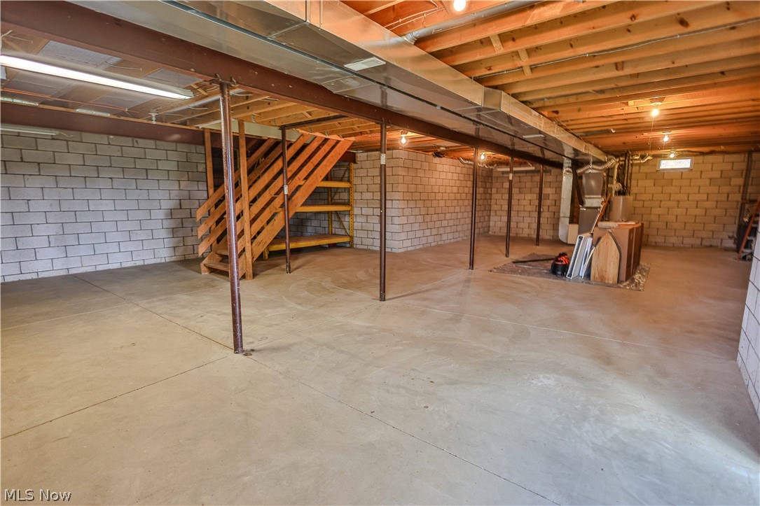 11154 Johnsford Road Southwest Beach City, OH 44608 - Photo 50 of 50 Spacious unfinished basement featuring concrete block walls and a concrete floor