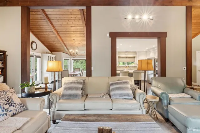 a dining room with stainless steel appliances kitchen island granite countertop a dining table chairs and granite counter tops