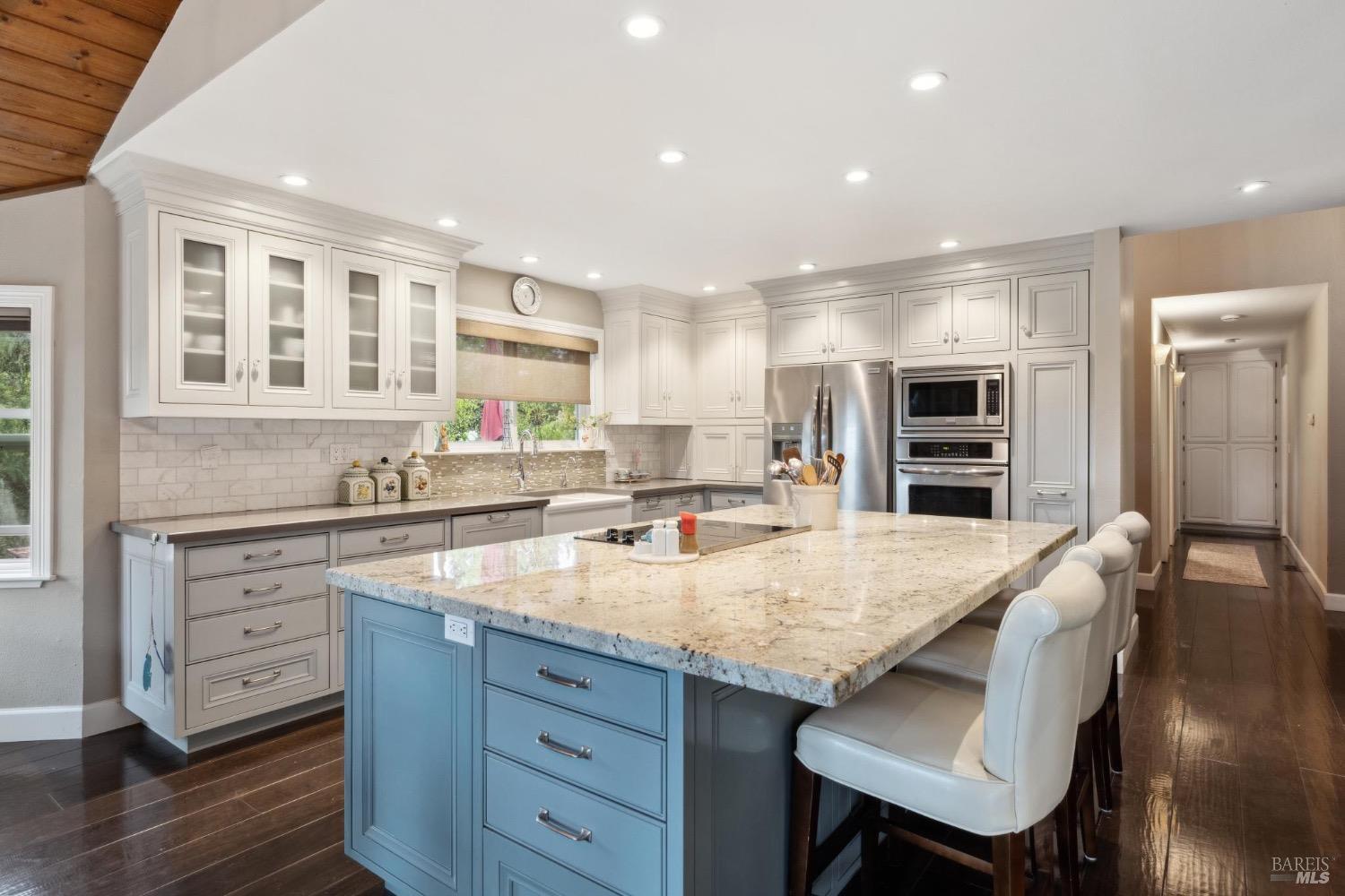 4560 Lovall Valley Loop Road Sonoma, CA 95476 - Photo 27 of 95 a kitchen with granite countertop a stove and chairs